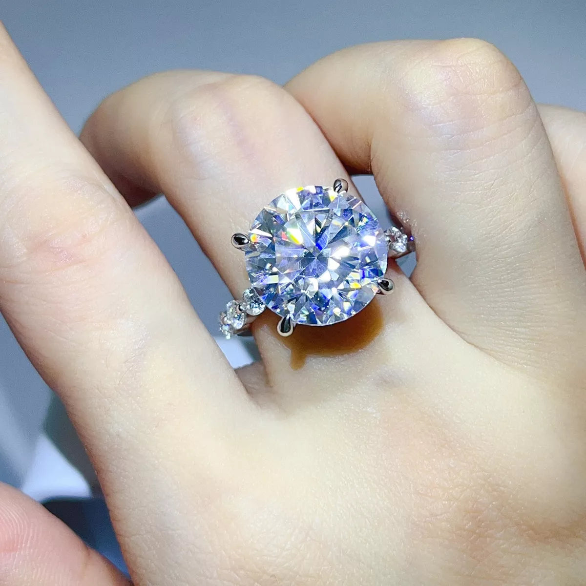 Clear round-stone ring worn on hand, showing elevated setting