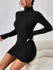 Side-angled view of the black long-sleeve turtleneck mini dress showing its fitted silhouette.