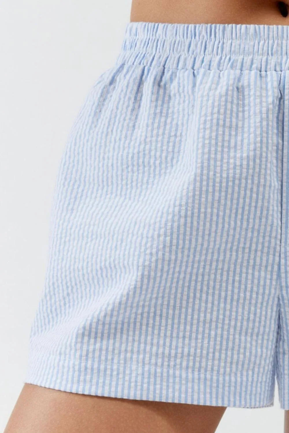 Close-up of pale blue vertical stripes and shorts leg opening