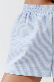 Close-up of pale blue vertical stripes and shorts leg opening
