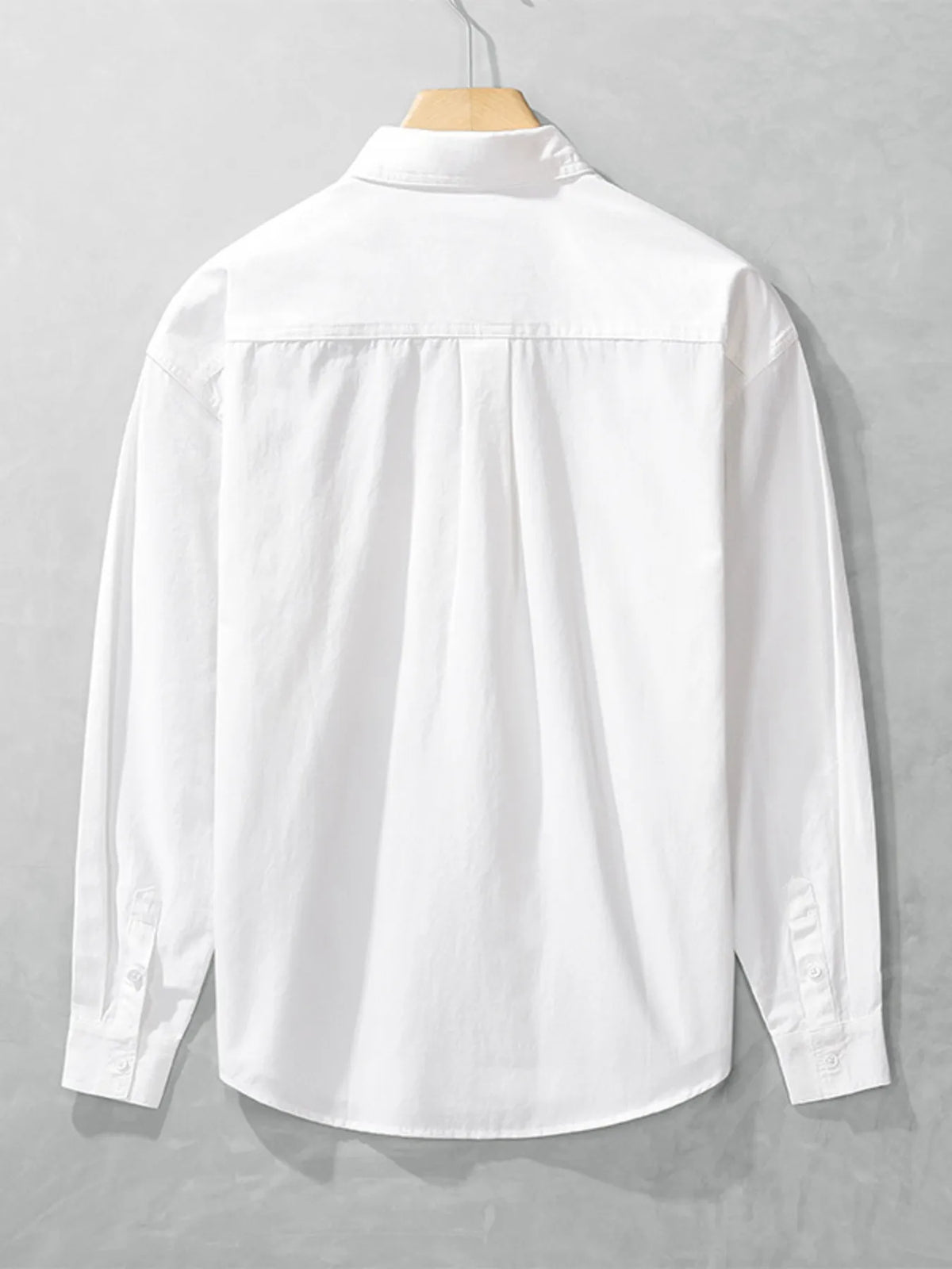 Back view of the white long-sleeve men's shirt showing its plain rear panel and shoulder seams