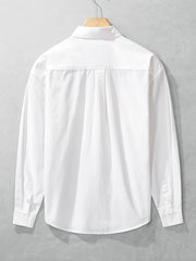 Back view of the white long-sleeve men's shirt showing its plain rear panel and shoulder seams