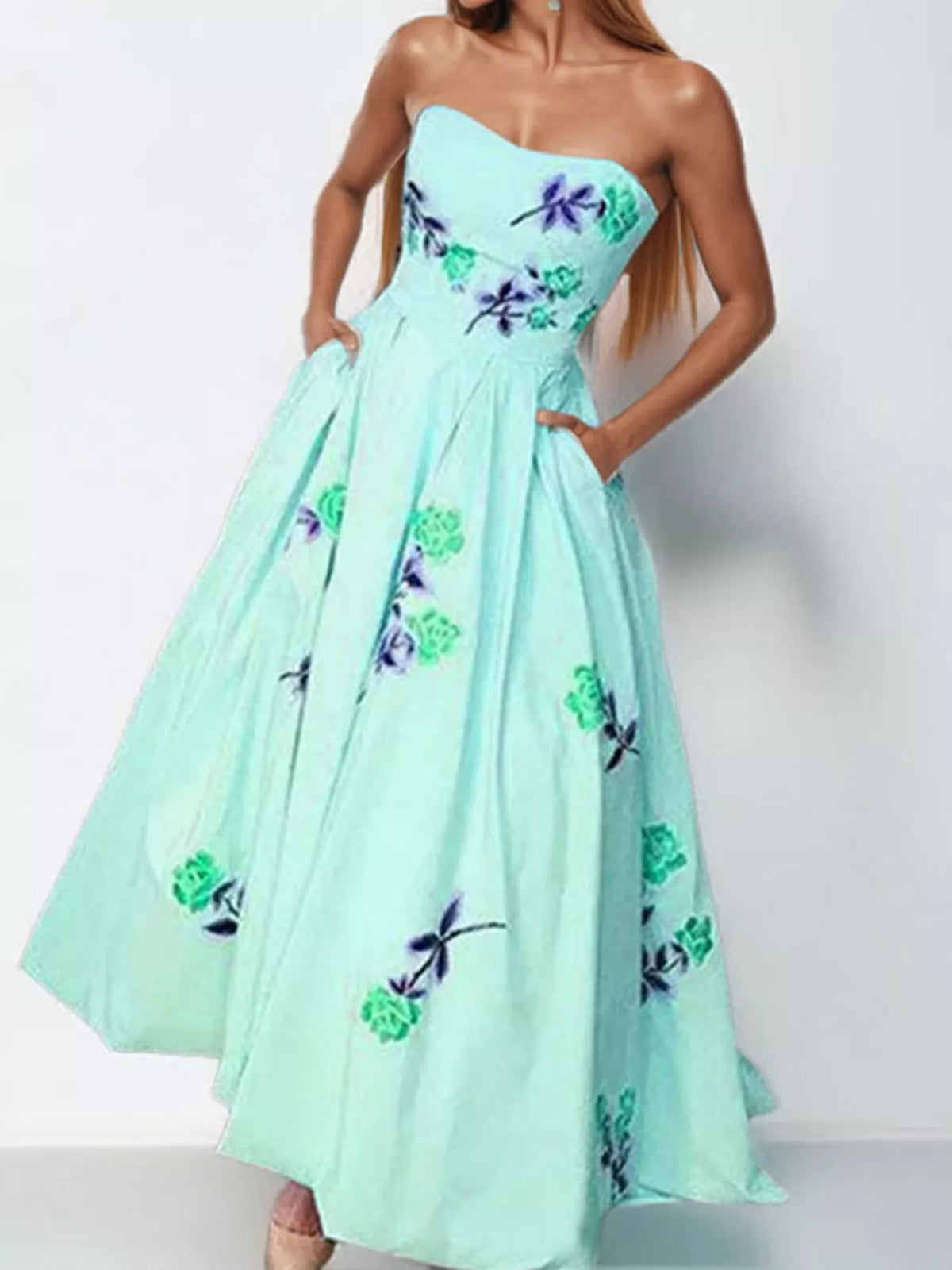 Model wearing a pale aqua strapless floral maxi dress, full-length front view.