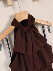 Close-up of the dark brown dress's back neckline and tie detail