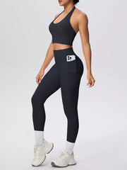 Angled side view of black halter set with phone pocket