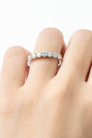 Close-up of a silver-tone ring with a row of round clear stones worn on a finger