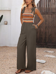Dark jumpsuit with patterned bodice shown full length