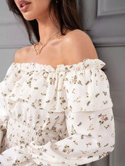 Close view of the white floral dress neckline, ruffled trim and off-shoulder sleeves.