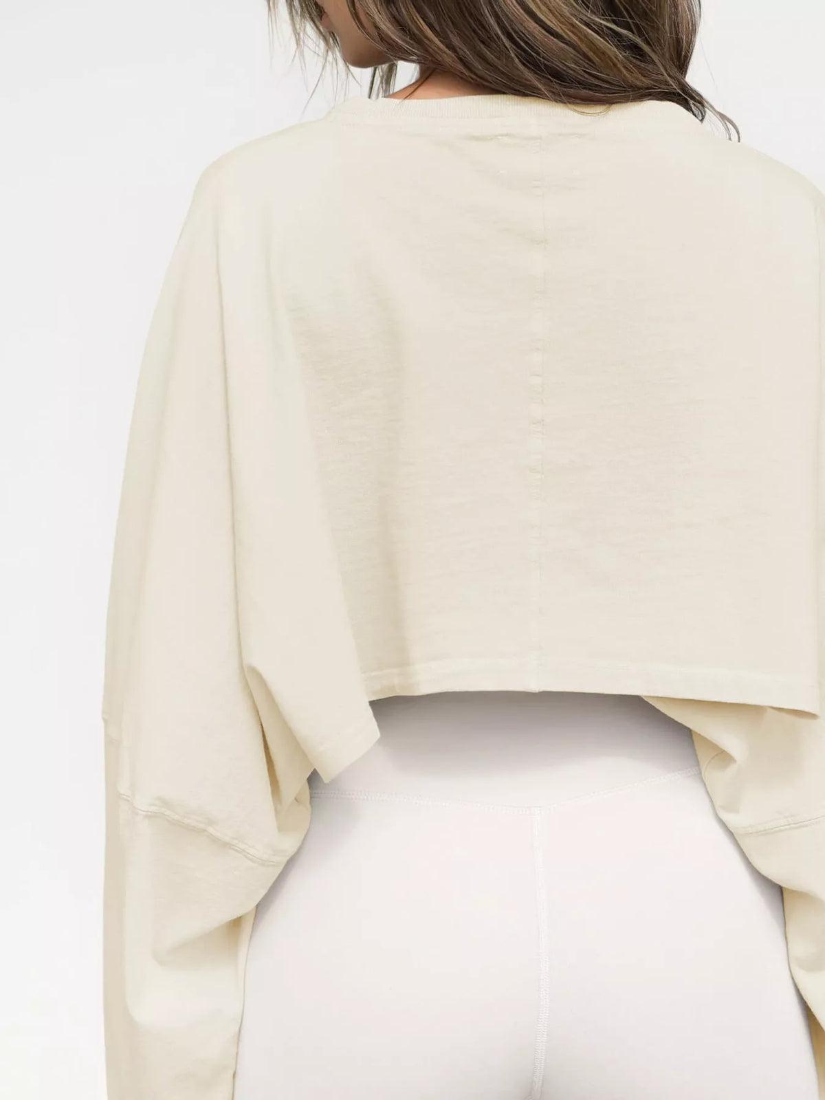 Back view of cream cropped sweatshirt with long sleeves
