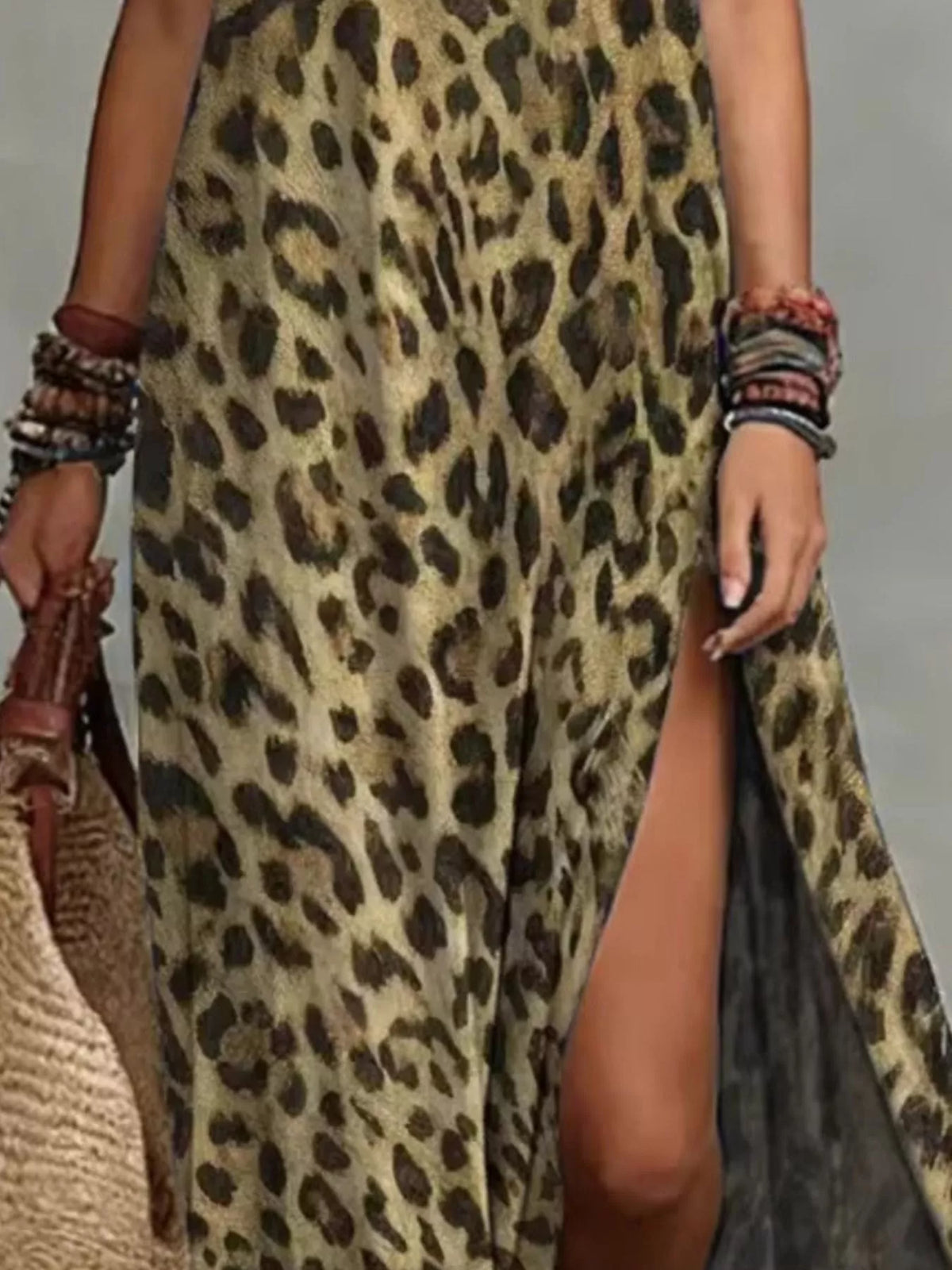 Close-up of the tan leopard-print maxi dress's side slit and loose skirt.