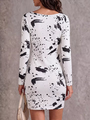 Back view of white long-sleeve mini dress with black paint-splatter pattern