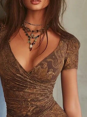 Close view of brown paisley print and V-neck ruched bodice