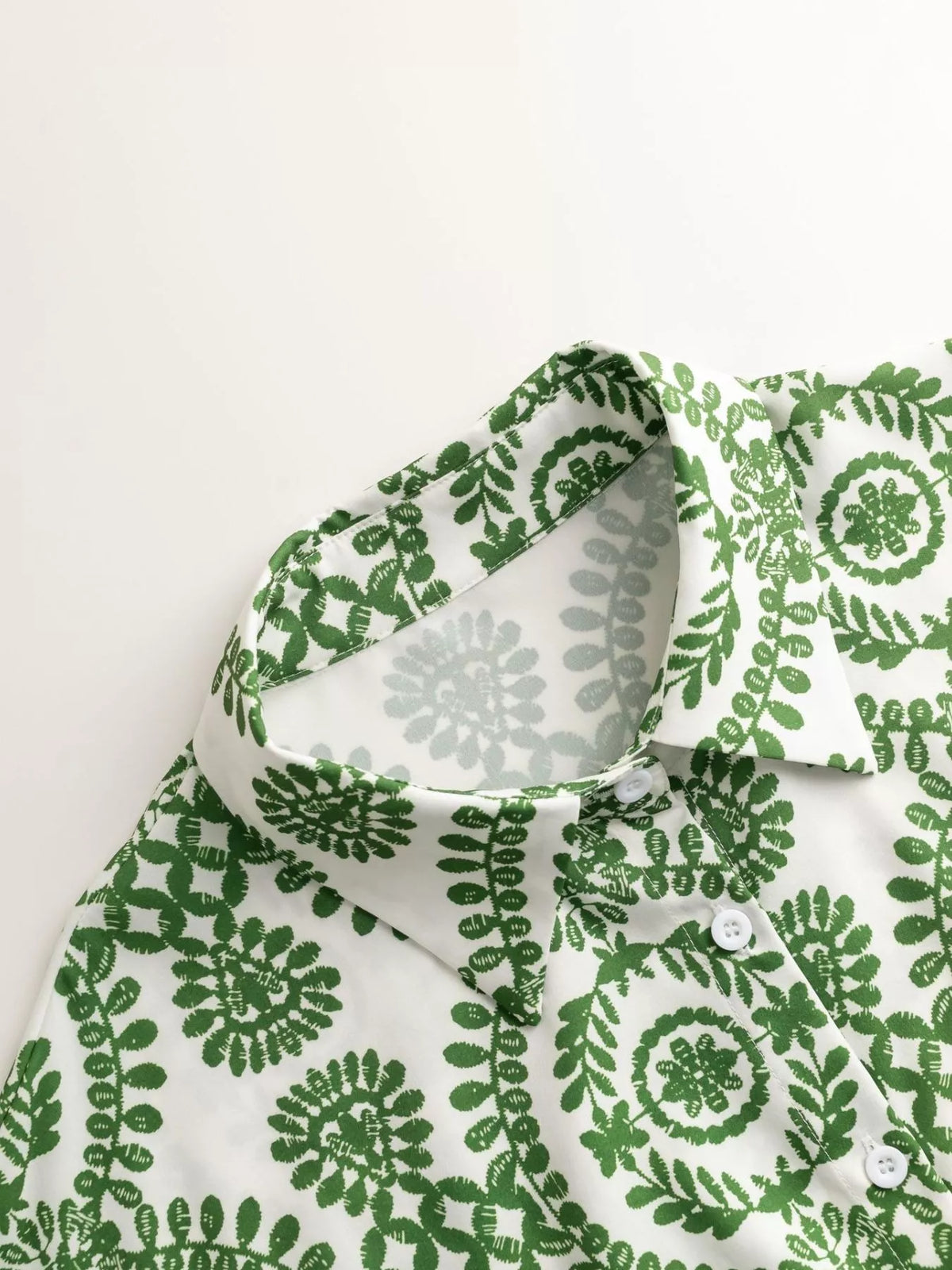 Women's printed tie-waist button-front romper, close-up of green print