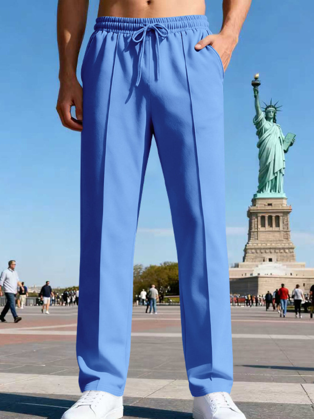 Front view of navy straight-leg pants in a city plaza.