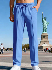 Front view of navy straight-leg pants in a city plaza.