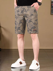 Front view of taupe botanical-print shorts on model