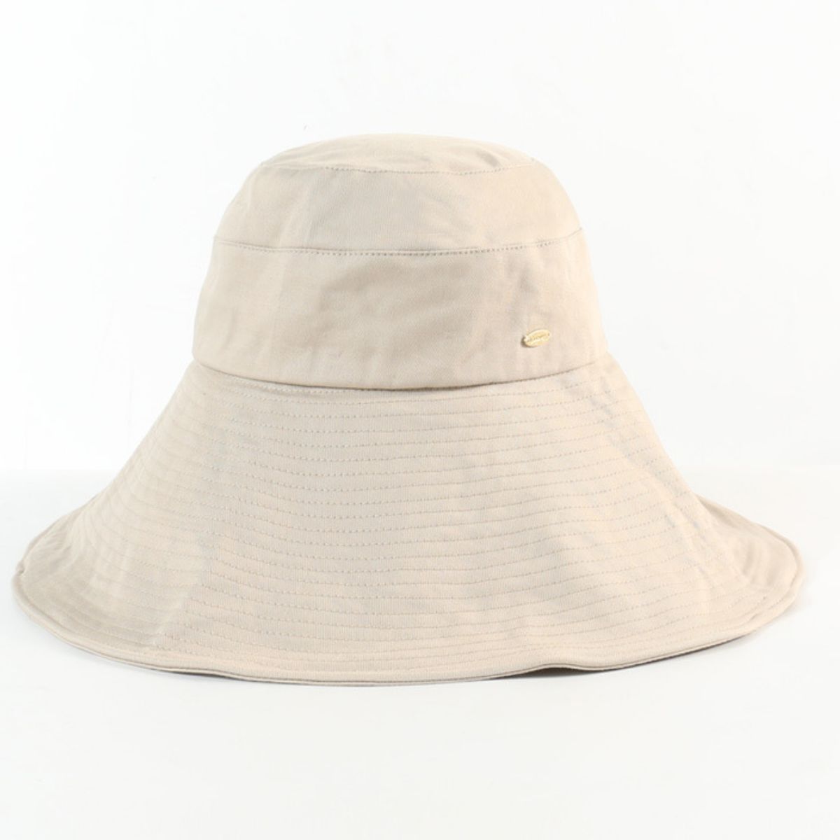 Beige cotton sun hat shown alone with a broad stitched brim and small side emblem.
