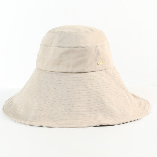 Beige cotton sun hat shown alone with a broad stitched brim and small side emblem.