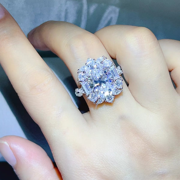 Cluster of clear stones on the 8 carat moissanite ring, worn on a hand.