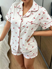 White pajama shirt with red cherry print and burgundy piping, front view