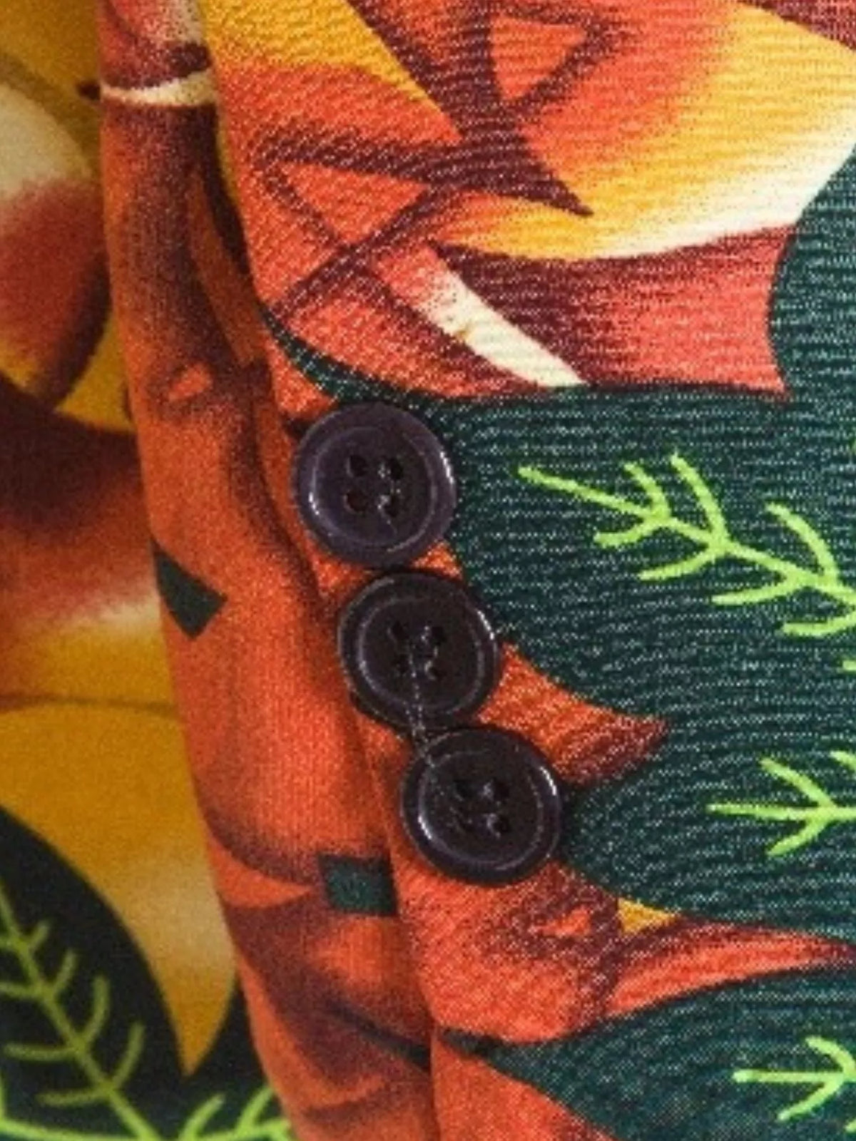 Close-up of the leaf print blazer front showing patterned fabric, lapel and buttons