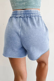 Model wearing light-blue drawstring shorts, back view