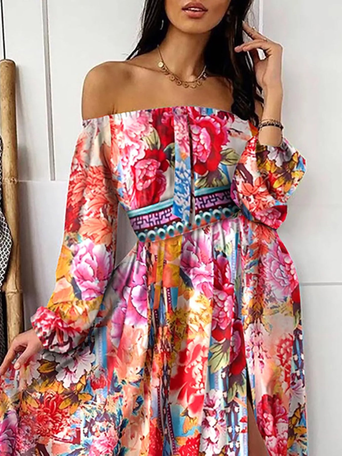 Model wearing the pink floral maxi dress with off-shoulder sleeves and a high slit.
