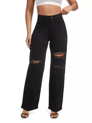 Front view of black ripped jeans with the model holding the waistband