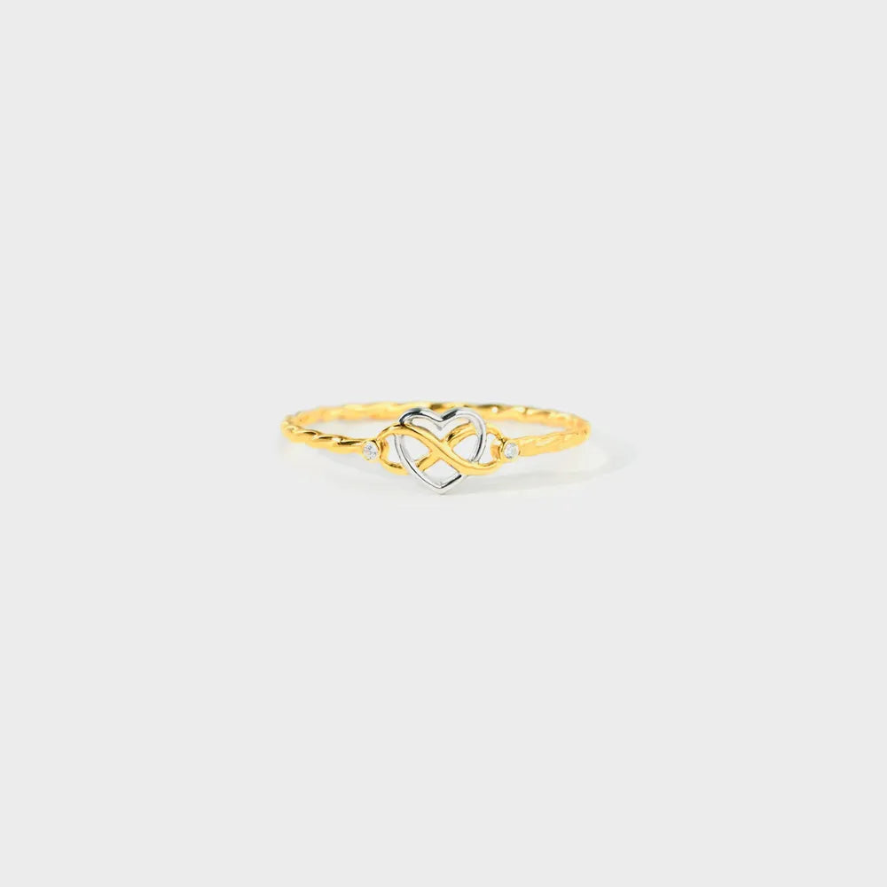 Gold-tone sterling silver ring with interlocking infinity heart motif on white