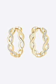 Pair of gold-tone crisscross hoops viewed from the side