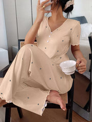 Seated model wearing beige heart-print loungewear set