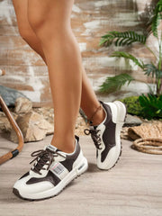 Black and white sneakers worn with shorts, side view