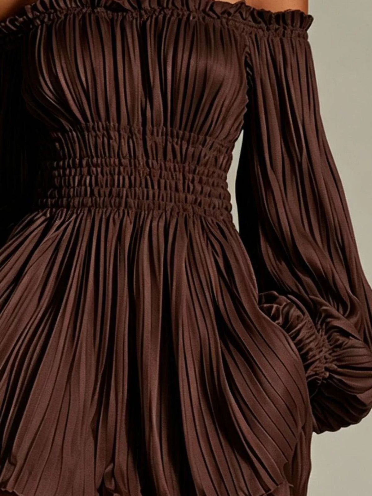 Close-up of dark brown dress showing pleats and smocked waist