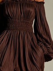 Close-up of dark brown dress showing pleats and smocked waist