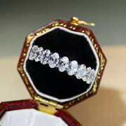 Silver zircon band displayed in a jewellery case.