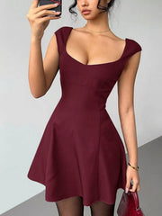Model wearing the burgundy sleeveless A-line mini dress, front view