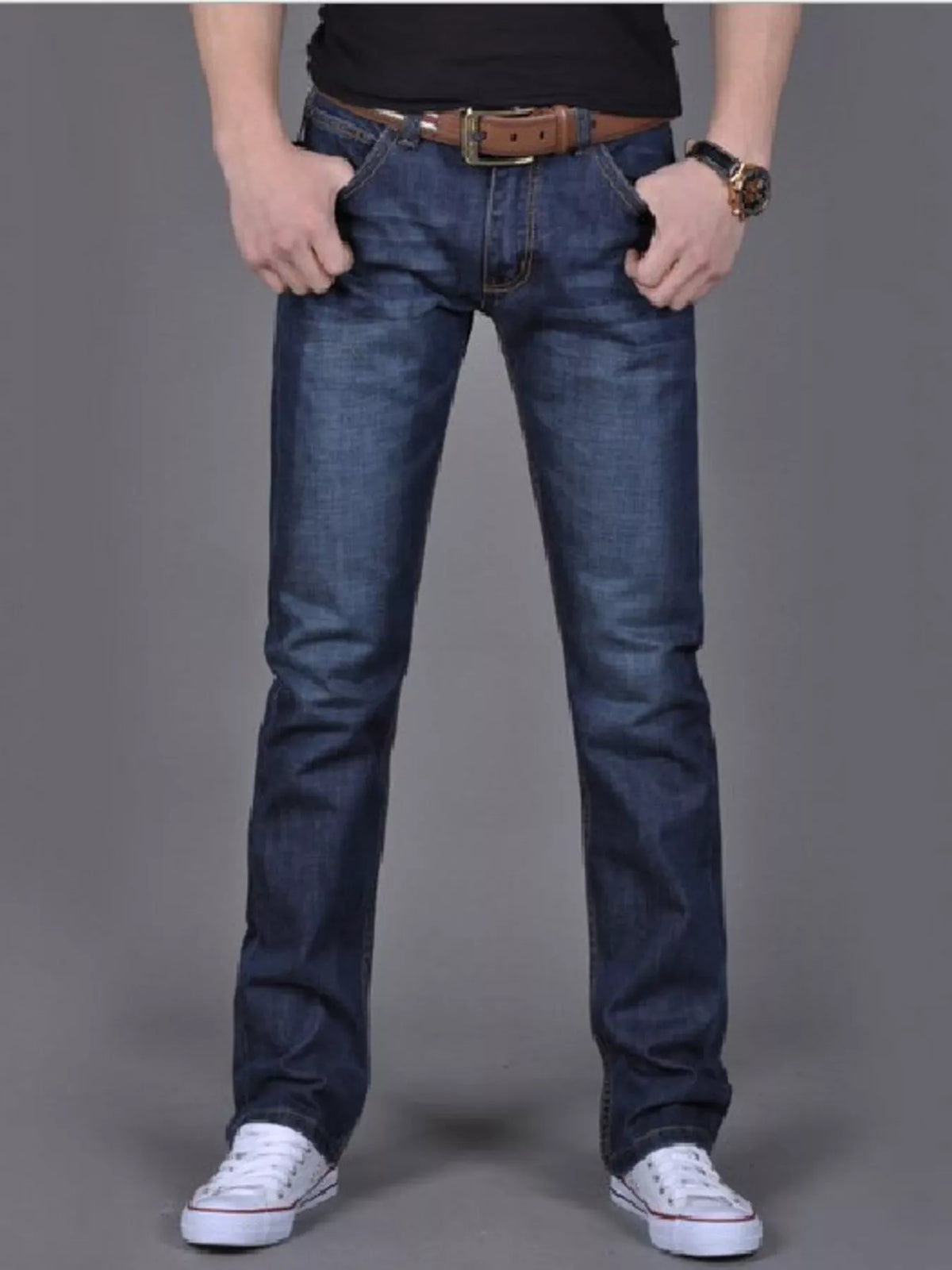 Model wearing dark blue slim-fit jeans, front view