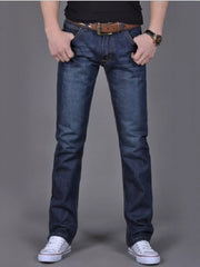 Model wearing dark blue slim-fit jeans, front view