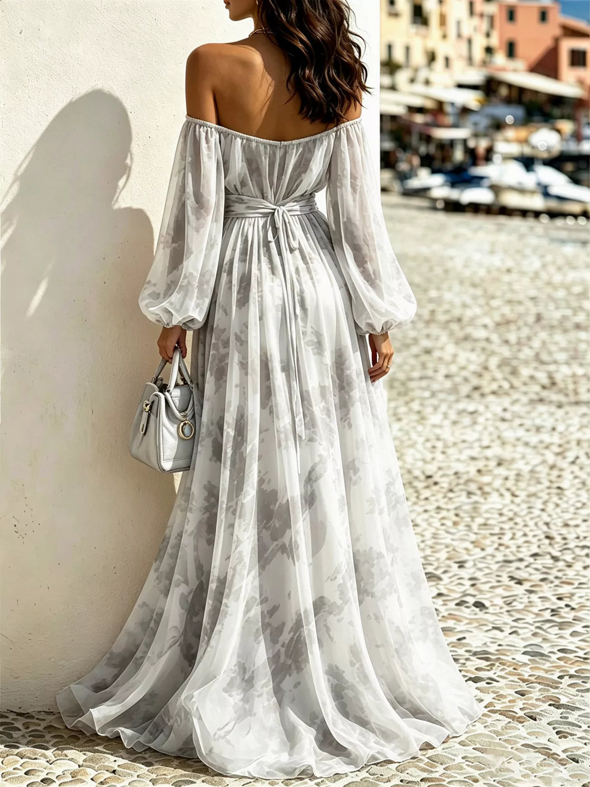 Back view of the grey patterned maxi dress showing the waist tie and flowing skirt