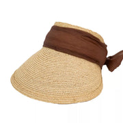 Front view of woven straw visor with coffee-brown band and side bow