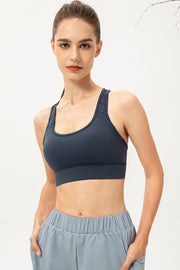 Model wearing navy scoop-neck sports bra, front view