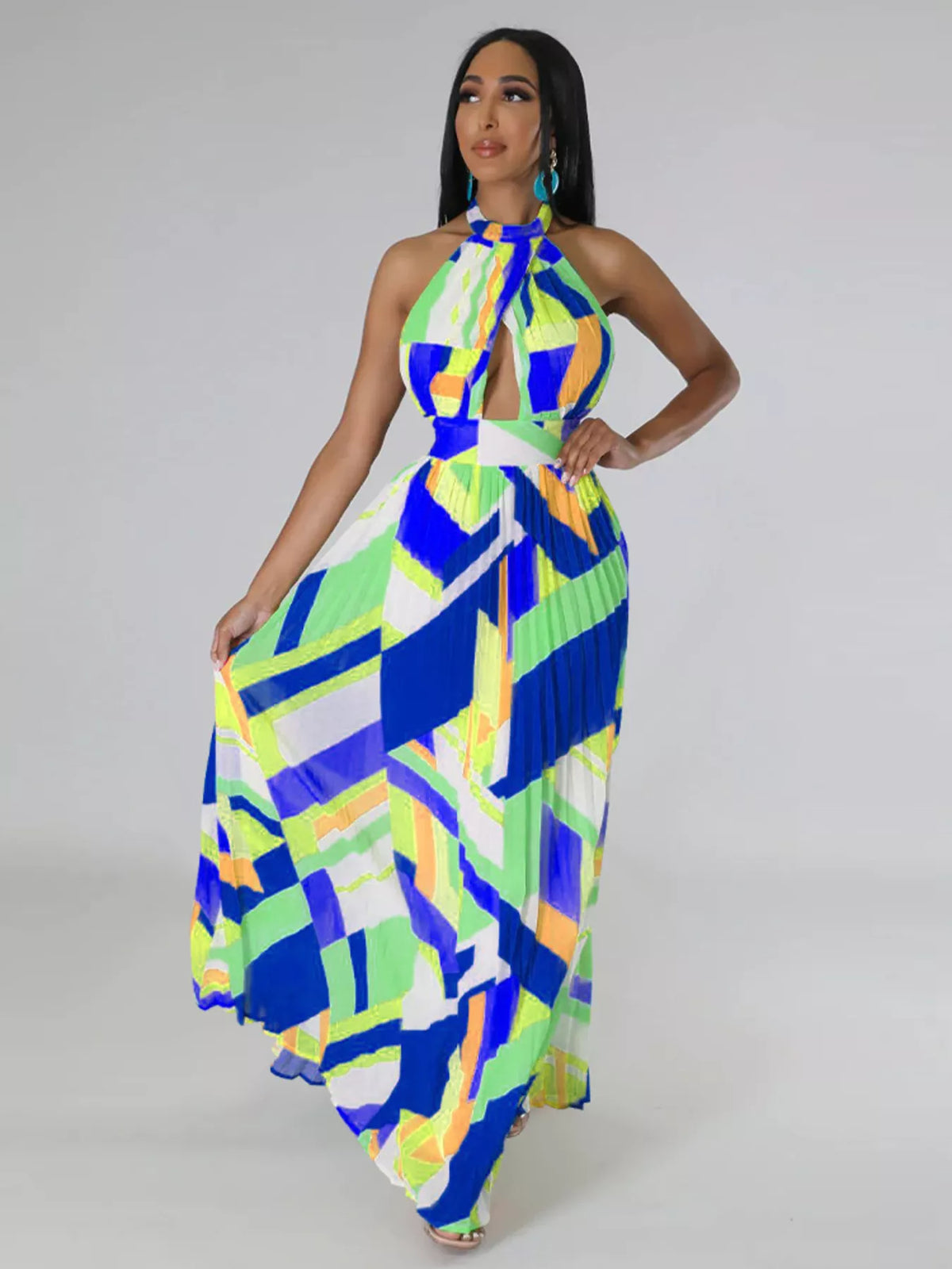 Blue and lime halter maxi dress on a model with one hand on her hip and the skirt fanned outward.