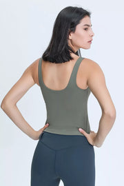 Front view of a woman wearing an olive green V-neck active tank.