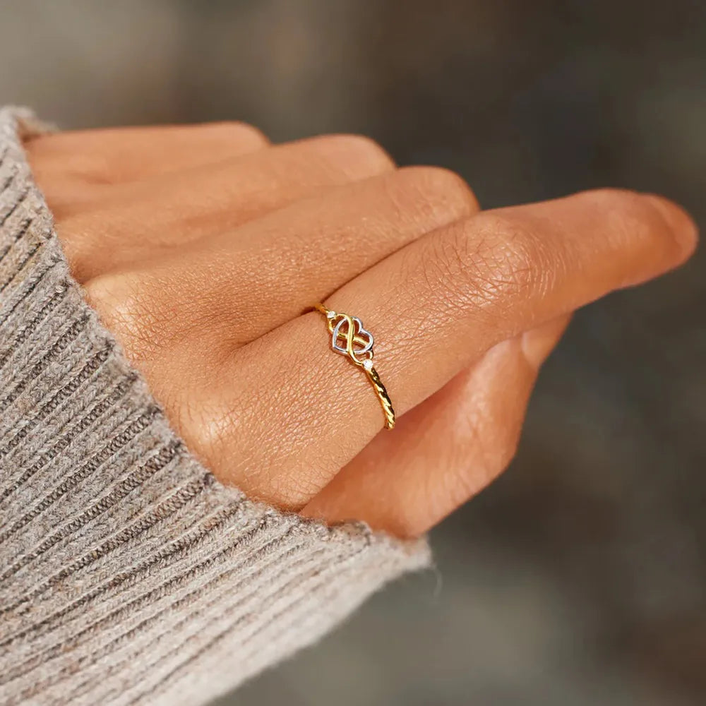 Close view of the infinity-heart ring on a finger