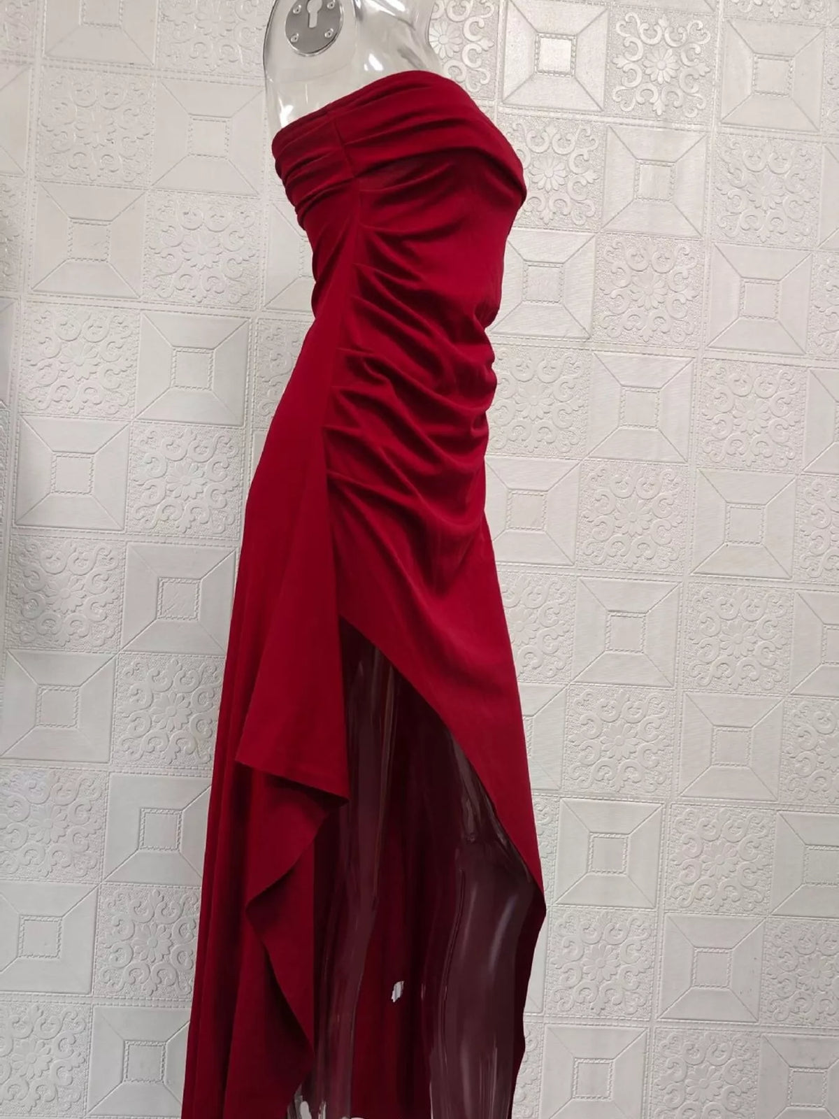 Burgundy ruched strapless dress on display form