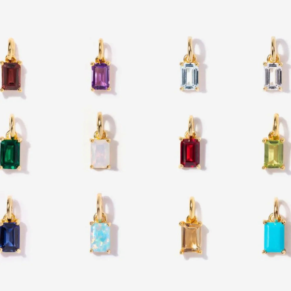 Twelve rectangular pendant colour options with gold-tone bails arranged in rows