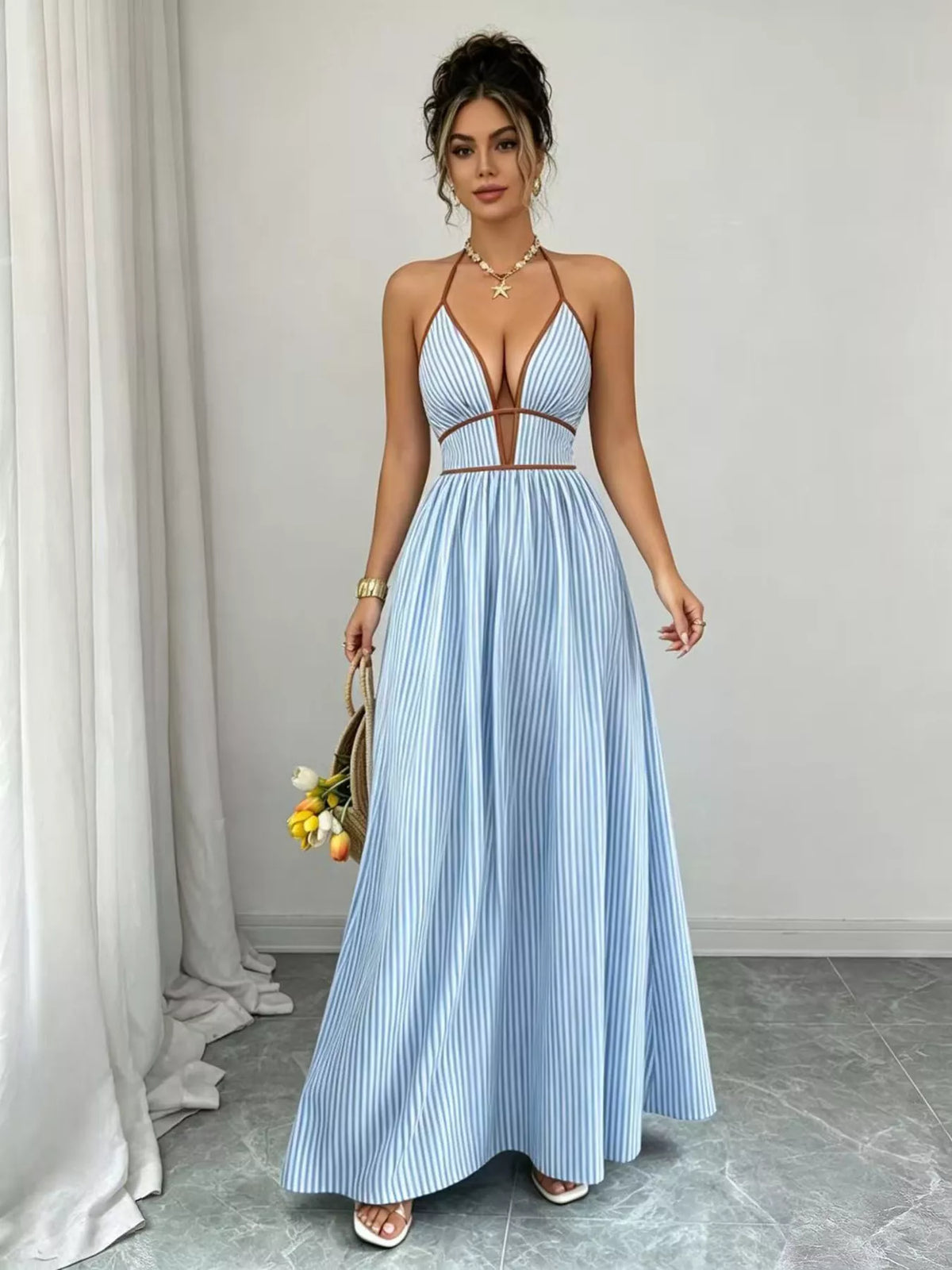 Light blue halter maxi dress shown full length with gathered waist