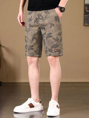 Side view of taupe botanical-print shorts on model