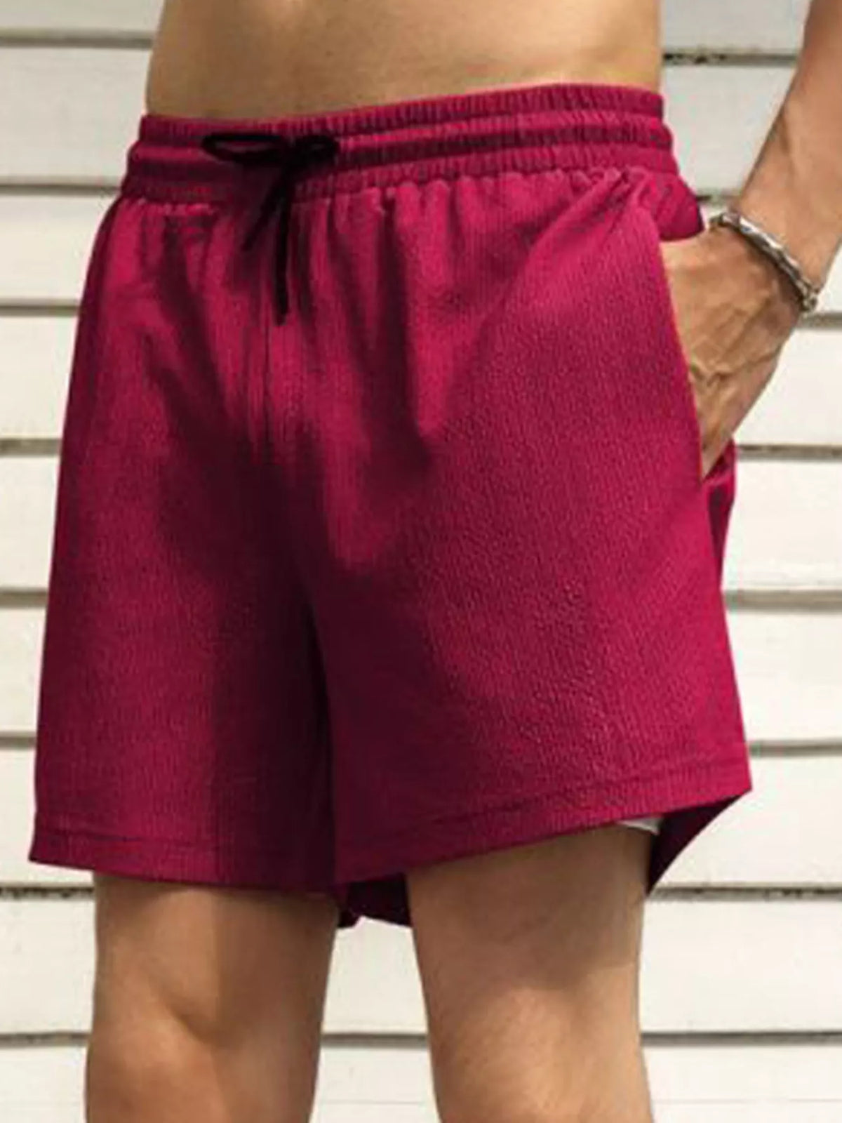 Model wearing magenta drawstring shorts, back view