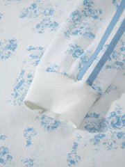 Close-up of ribbed cuff and blue stripe on floral sweatshirt sleeve
